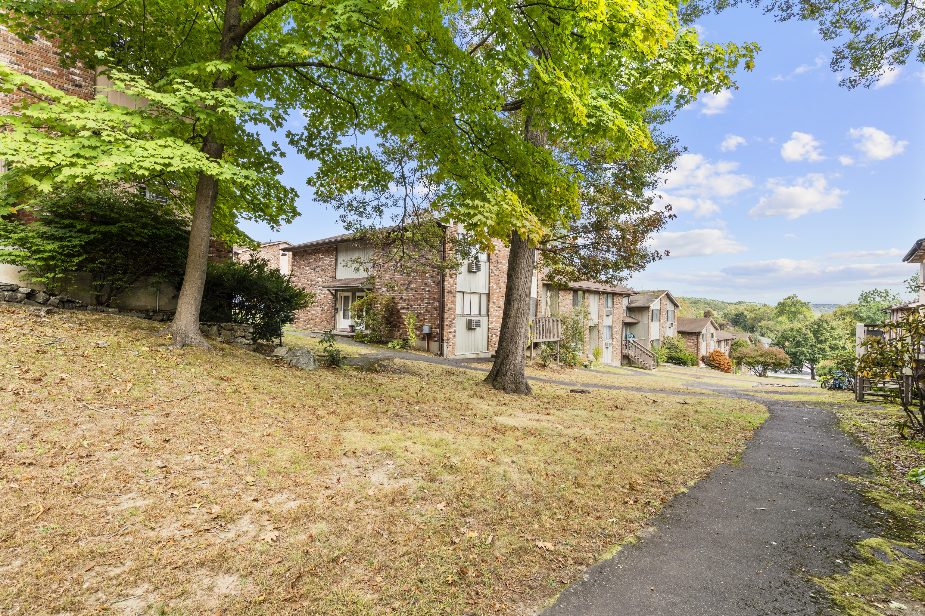 203 Kaynor Drive, Unit B Waterbury, CT 06708 - Photo 33 of 36 a view of a house with a yard