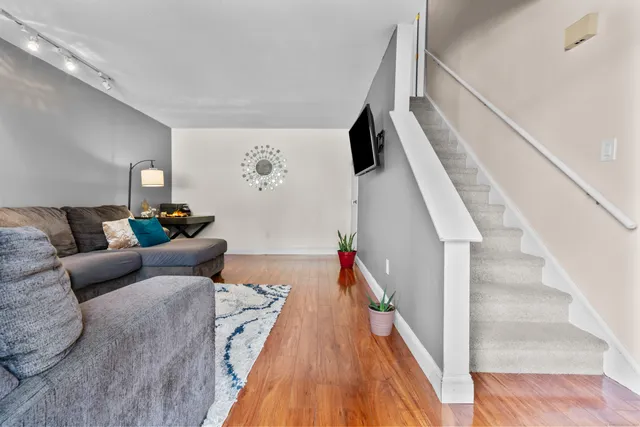 a living room with furniture and wooden floor