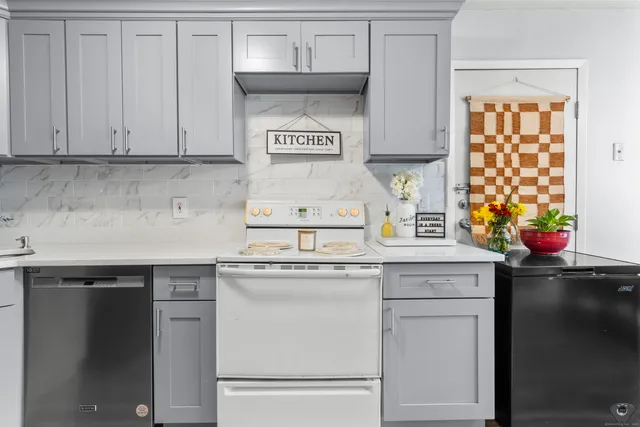 a kitchen with stainless steel appliances granite countertop a sink stove and cabinets