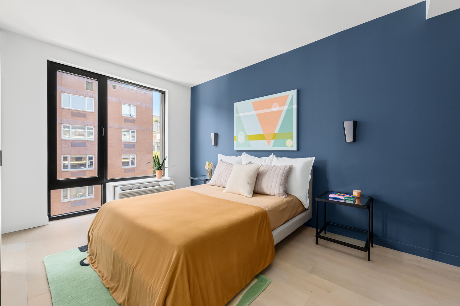 181 East 101st Street, Unit 809 Manhattan, NY 10029 - Photo 3 of 13 a bedroom with a bed and a large window