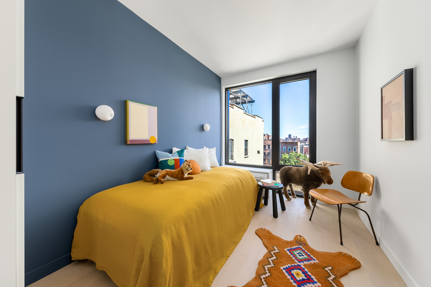 181 East 101st Street, Unit 809 Manhattan, NY 10029 - Photo 6 of 13 a bed sitting in a bedroom next to a window