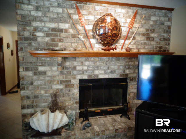 2804 Pine Ridge Drive Lillian, AL 36549 - Photo 8 of 39 20 x 14.Beautiful Wood burning fireplace with glass doors, mantle and brick hearth.
