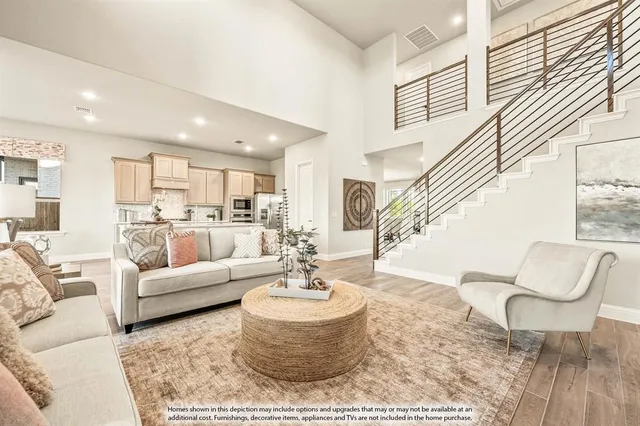 a living room with furniture and a dining table with kitchen view