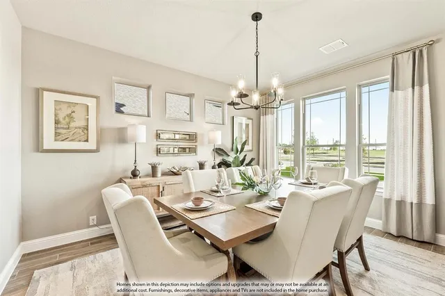 a dining room with furniture a chandelier and wooden floor