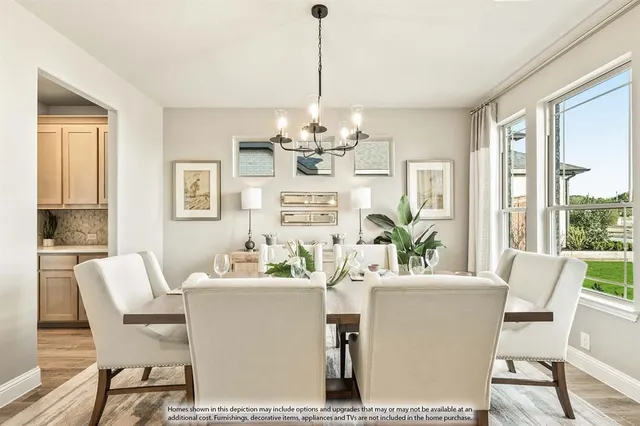 a dining room with furniture a chandelier and wooden floor