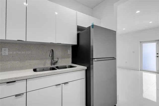 a kitchen with stainless steel appliances granite countertop a sink stove a microwave and cabinets