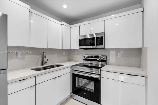a kitchen with a refrigerator sink and white stove