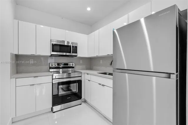 a kitchen with stainless steel appliances granite countertop a stove and a sink