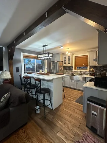 a kitchen with stainless steel appliances kitchen island granite countertop a sink and counter space
