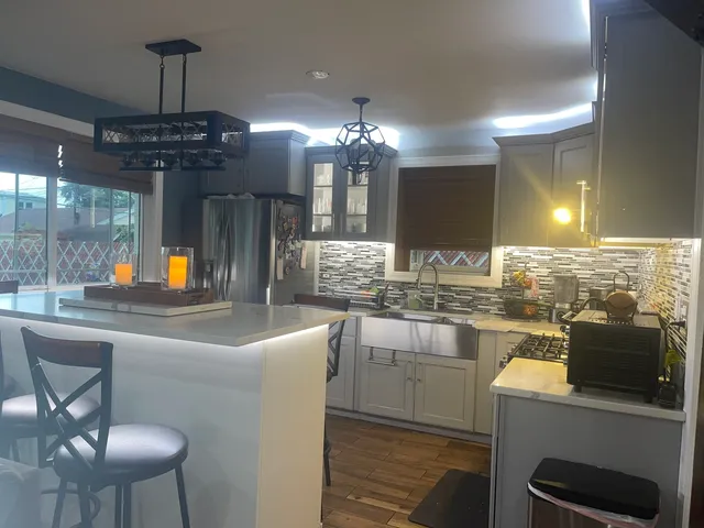 a kitchen with counter top space and dining table
