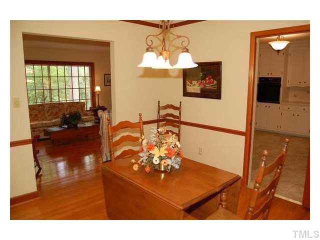 6305 Arnold Road Raleigh, NC 27607 - Photo 5 of 25 a living room with furniture and a flat screen tv