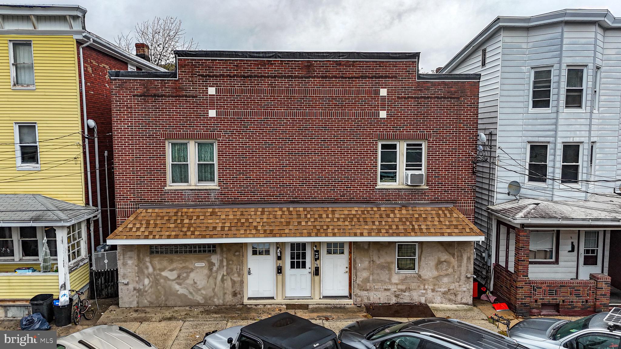 231 East Ridge Street Lansford, PA 18232 - Photo 4 of 7 a front view of a house with parking space
