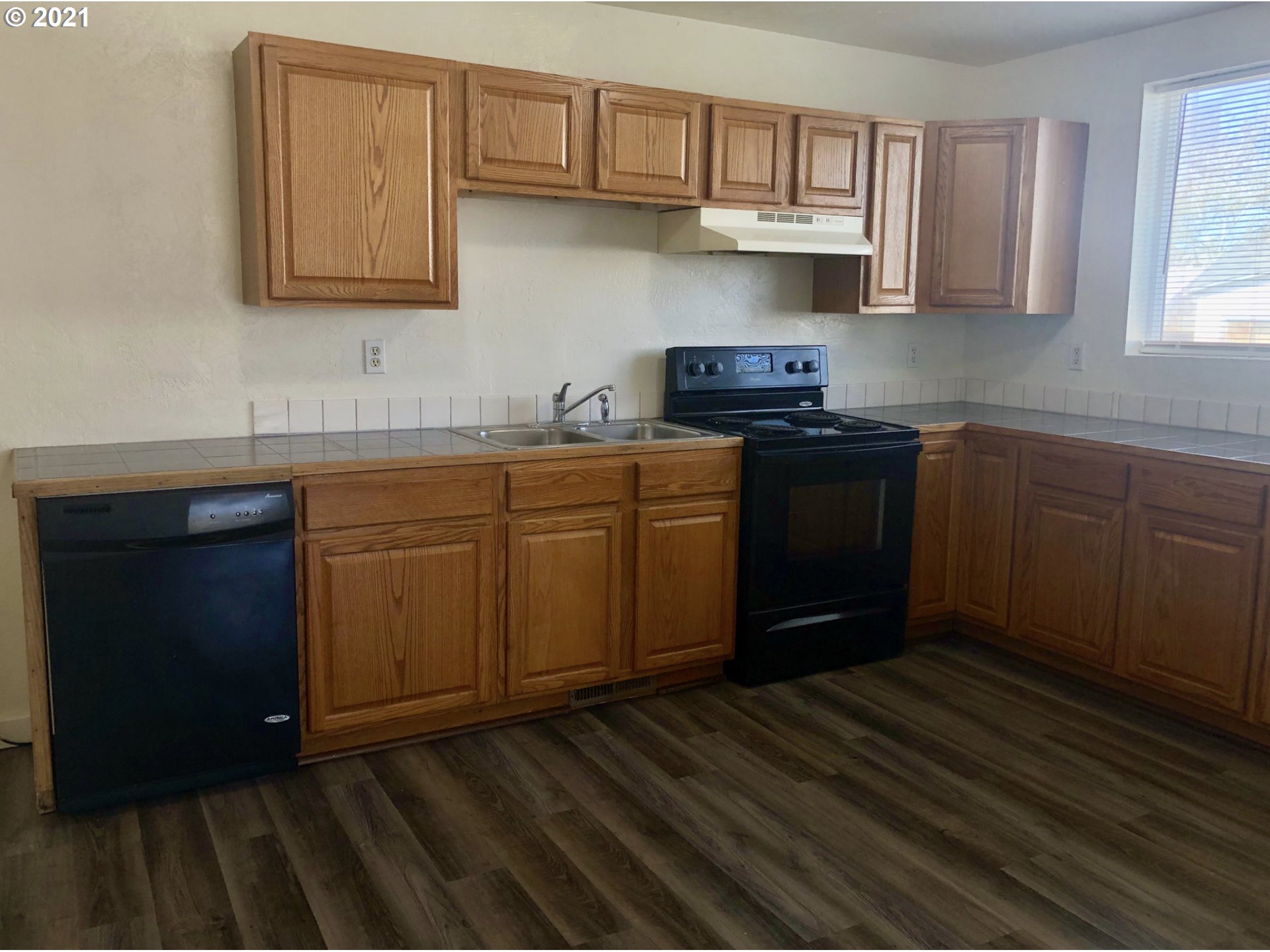 623 Southwest 4th Street Pendleton, OR 97801 - Photo 14 of 32 a kitchen with stainless steel appliances granite countertop a stove a sink dishwasher and cabinets with wooden floor