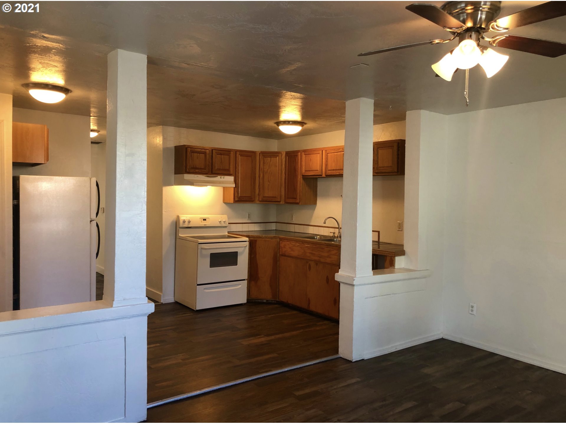 623 Southwest 4th Street Pendleton, OR 97801 - Photo 2 of 32 a kitchen with a refrigerator and a stove