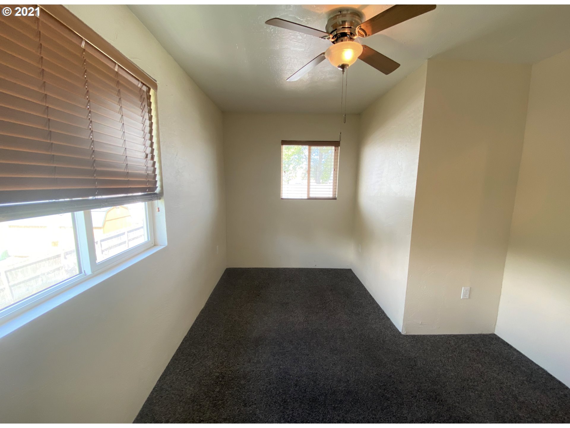 623 Southwest 4th Street Pendleton, OR 97801 - Photo 24 of 32 an empty room with windows and fan