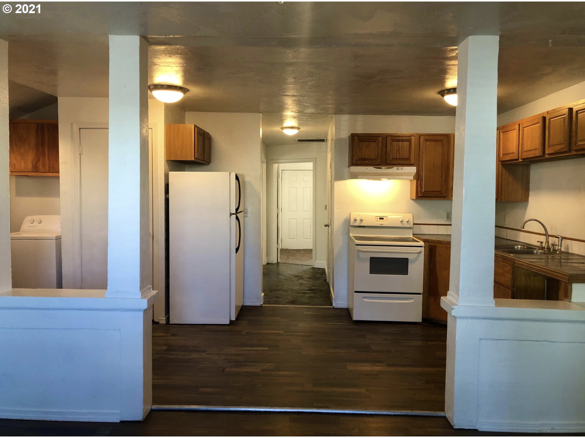 623 Southwest 4th Street Pendleton, OR 97801 - Photo 3 of 32 a kitchen with stainless steel appliances kitchen island granite countertop a refrigerator stove and oven