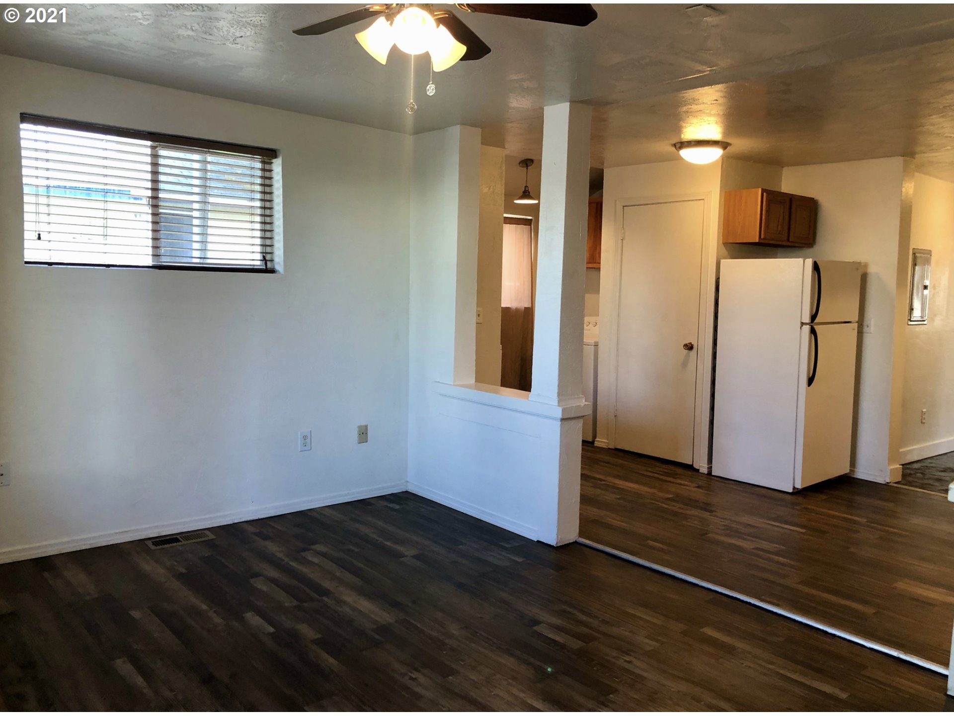 623 Southwest 4th Street Pendleton, OR 97801 - Photo 4 of 32 an empty room with wooden floor and windows