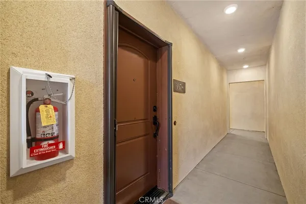 a view of a patio with couches and table and chairs and potted plants