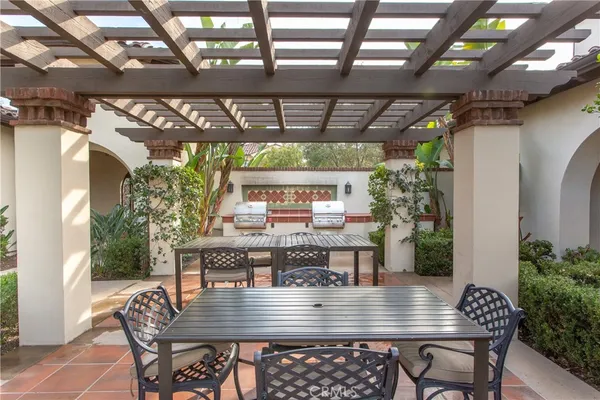 a view of a patio with couches chairs and a potted plant