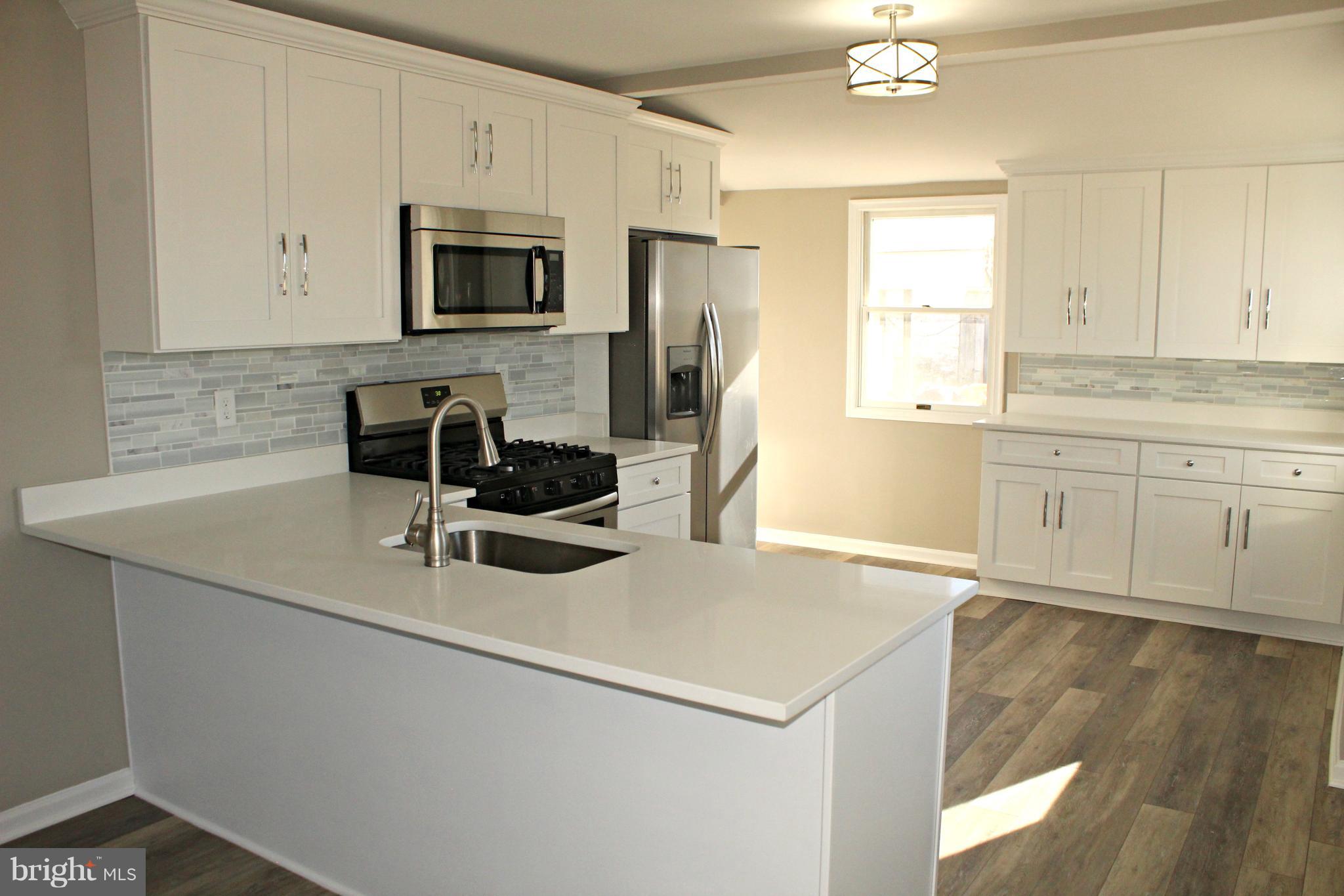 1723 Leslie Road Baltimore, MD 21222 - Photo 2 of 23 New kitchen with quartz and stainless steel!