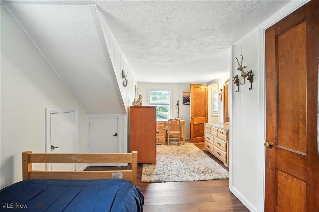 194 Ansel Road Geneva, OH 44041 - Photo 31 of 41 Bedroom featuring a textured ceiling and wood finished floors