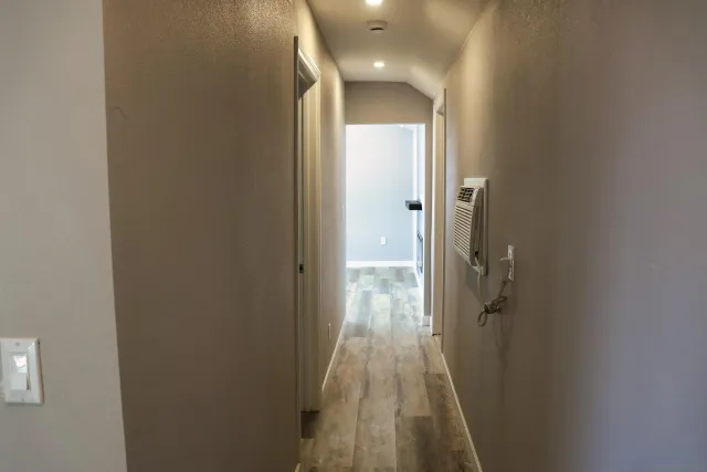 a bathroom with a granite countertop toilet sink and mirror