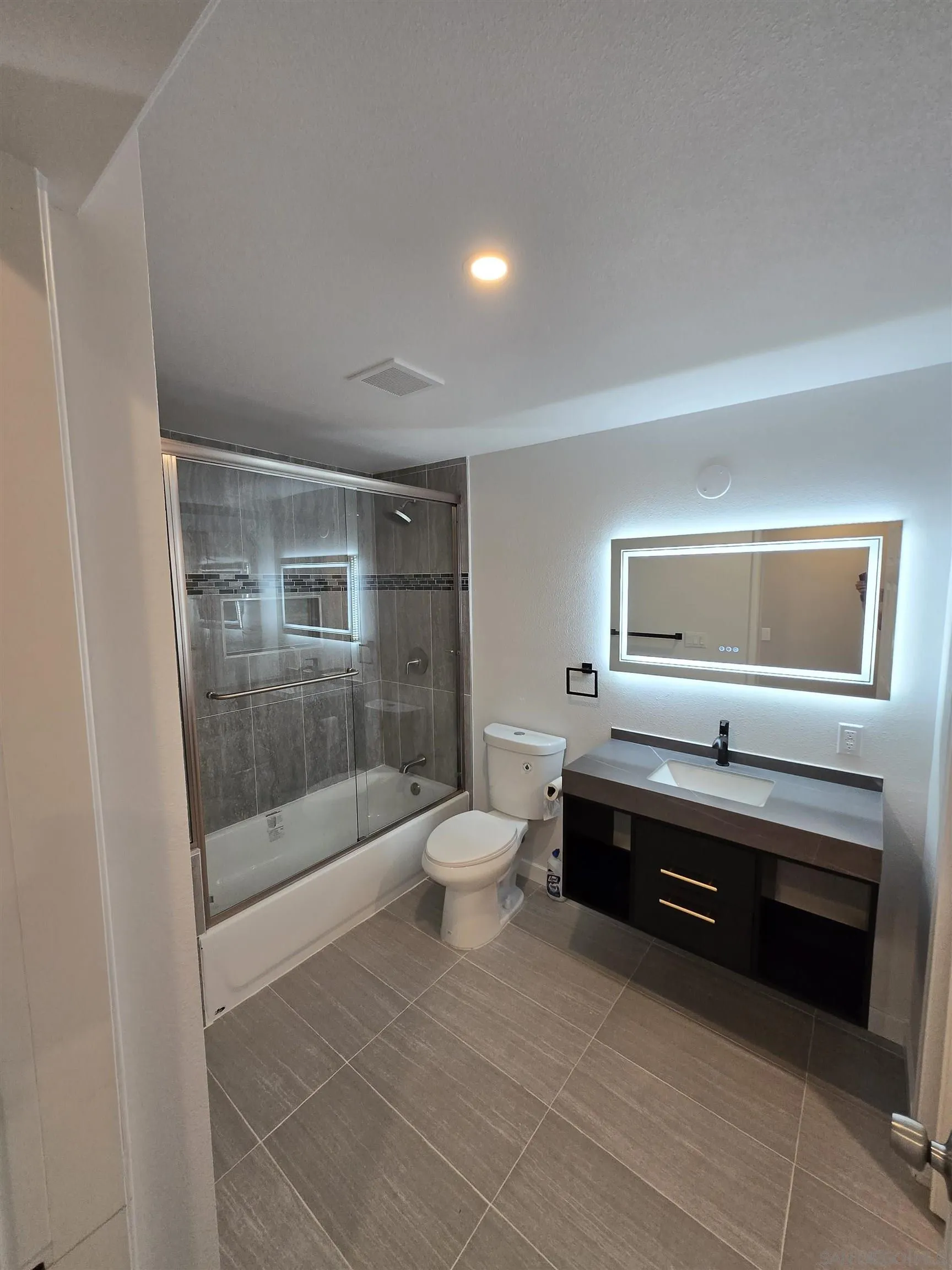 940 South Upas Street Escondido, CA 92025 - Photo 19 of 55 a bathroom with a sink a toilet and shower