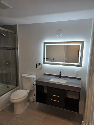 a bathroom with a shower and a toilet