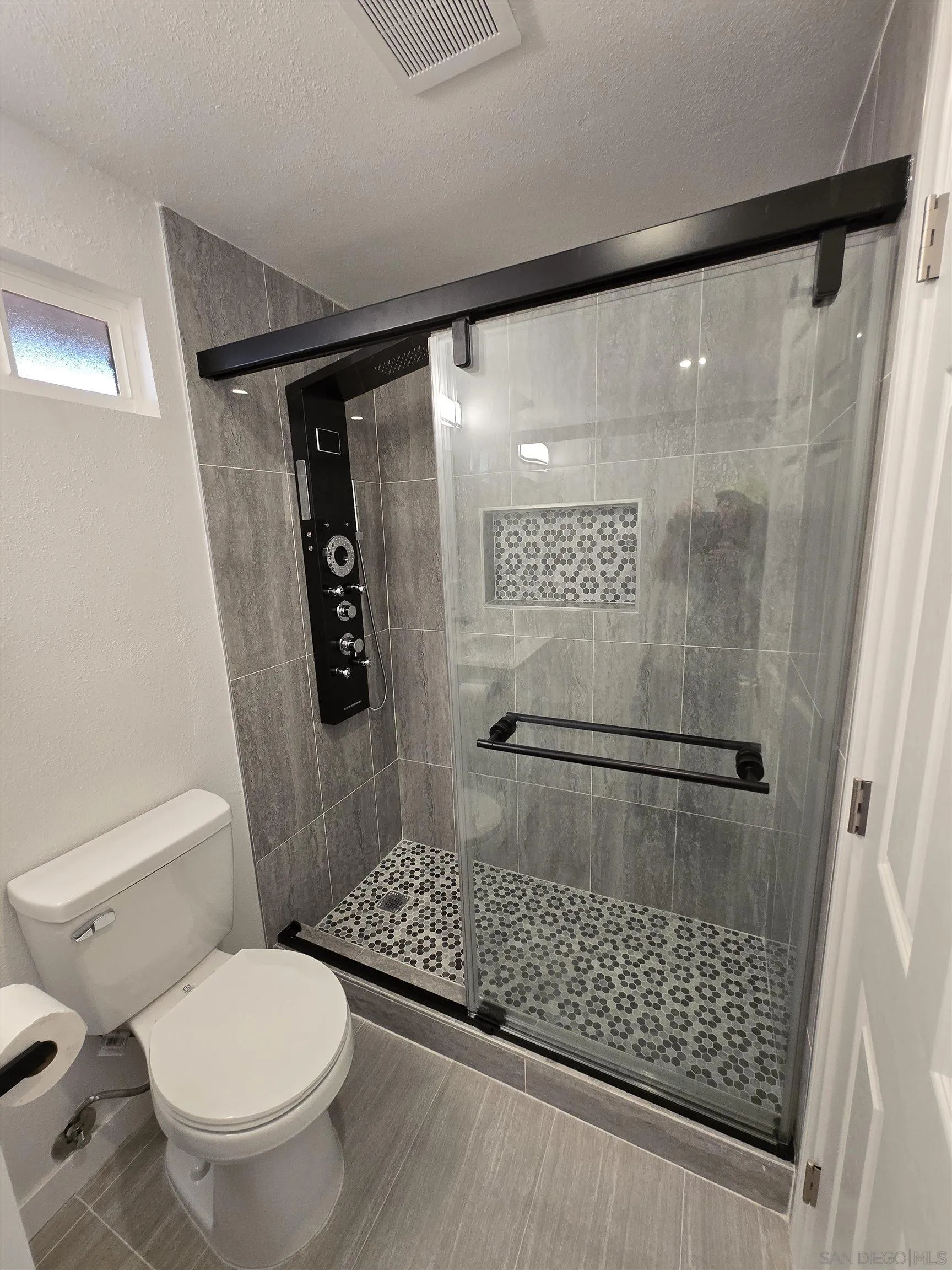 940 South Upas Street Escondido, CA 92025 - Photo 25 of 55 a bathroom with a toilet and a shower