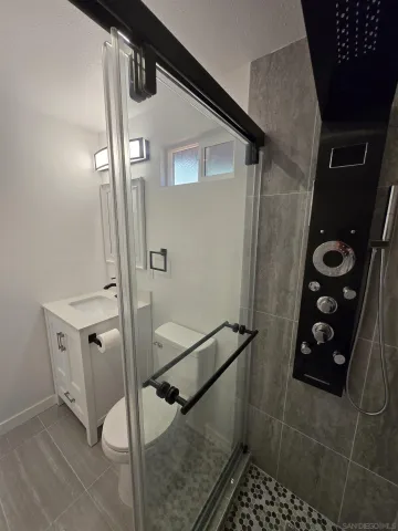 a view of a room with wooden floor and chandelier