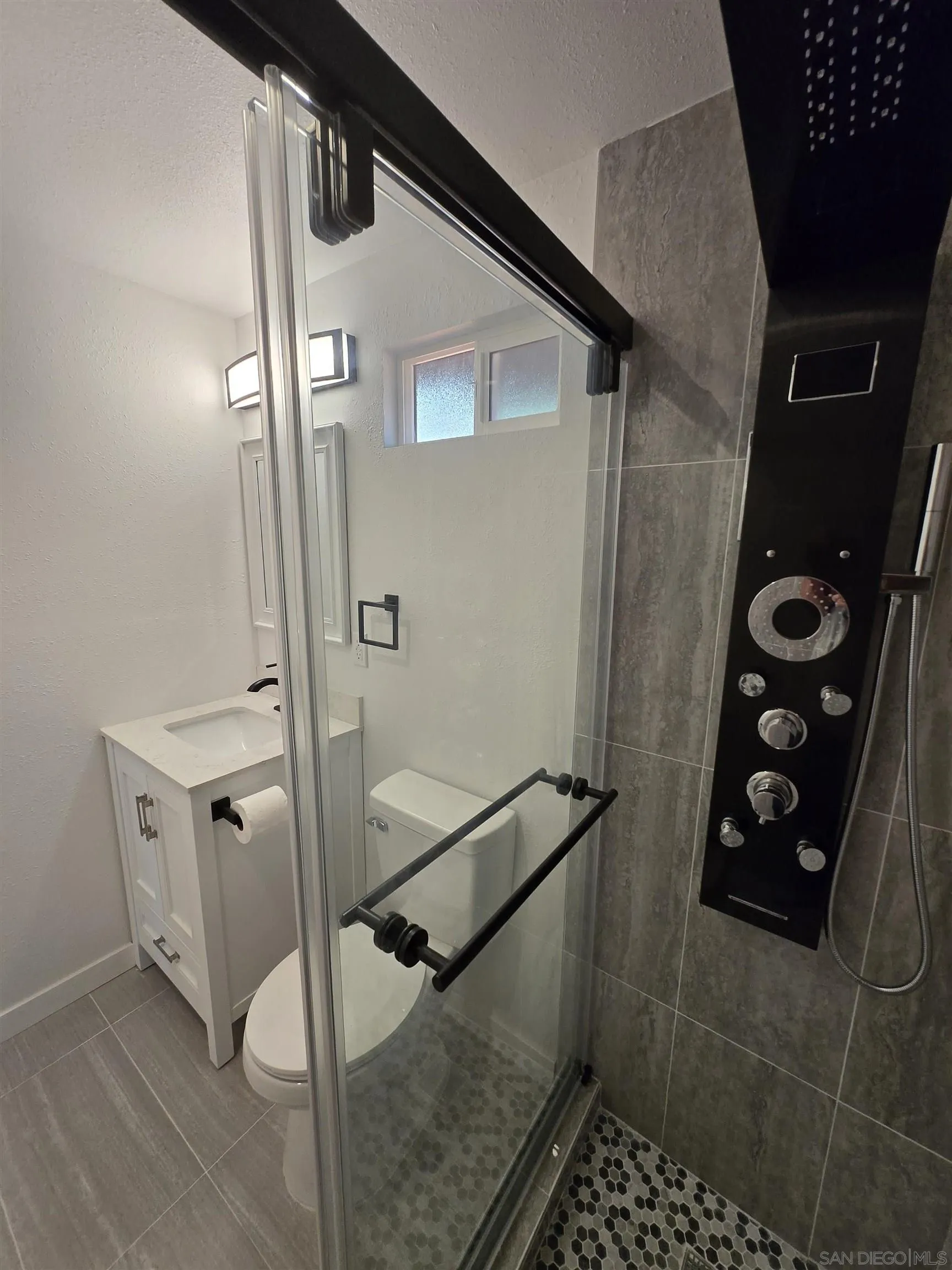 940 South Upas Street Escondido, CA 92025 - Photo 27 of 55 a bathroom with a shower and a mirror