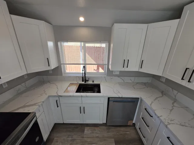 a view of a room with wooden floor and a bathroom