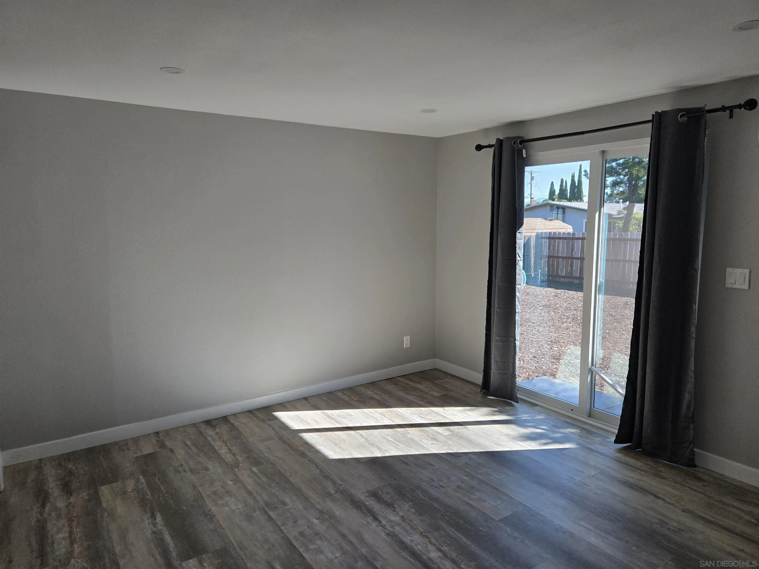 940 South Upas Street Escondido, CA 92025 - Photo 33 of 55 an empty room with wooden floor and windows