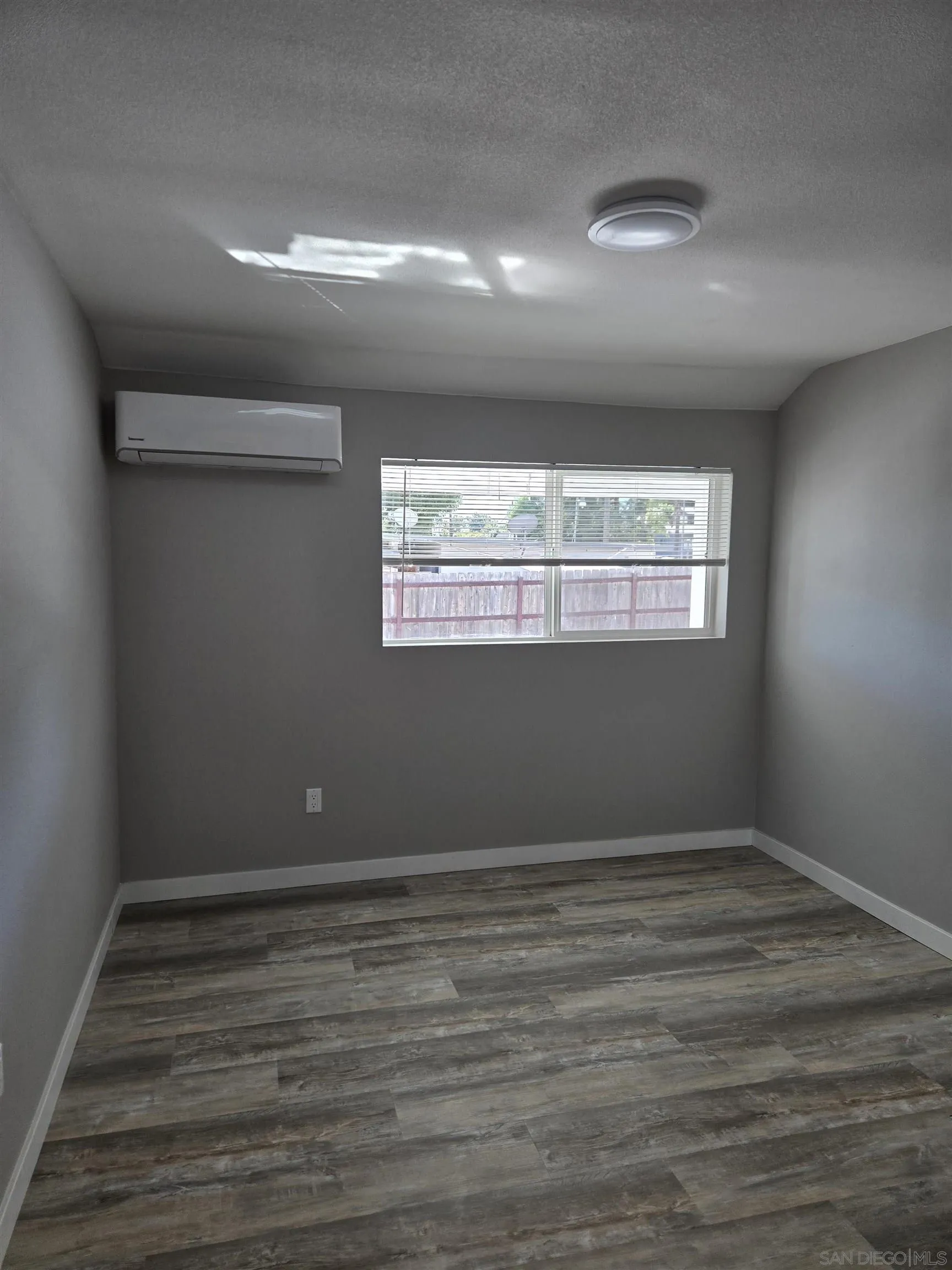 940 South Upas Street Escondido, CA 92025 - Photo 40 of 55 a view of an empty room with wooden floor and a window