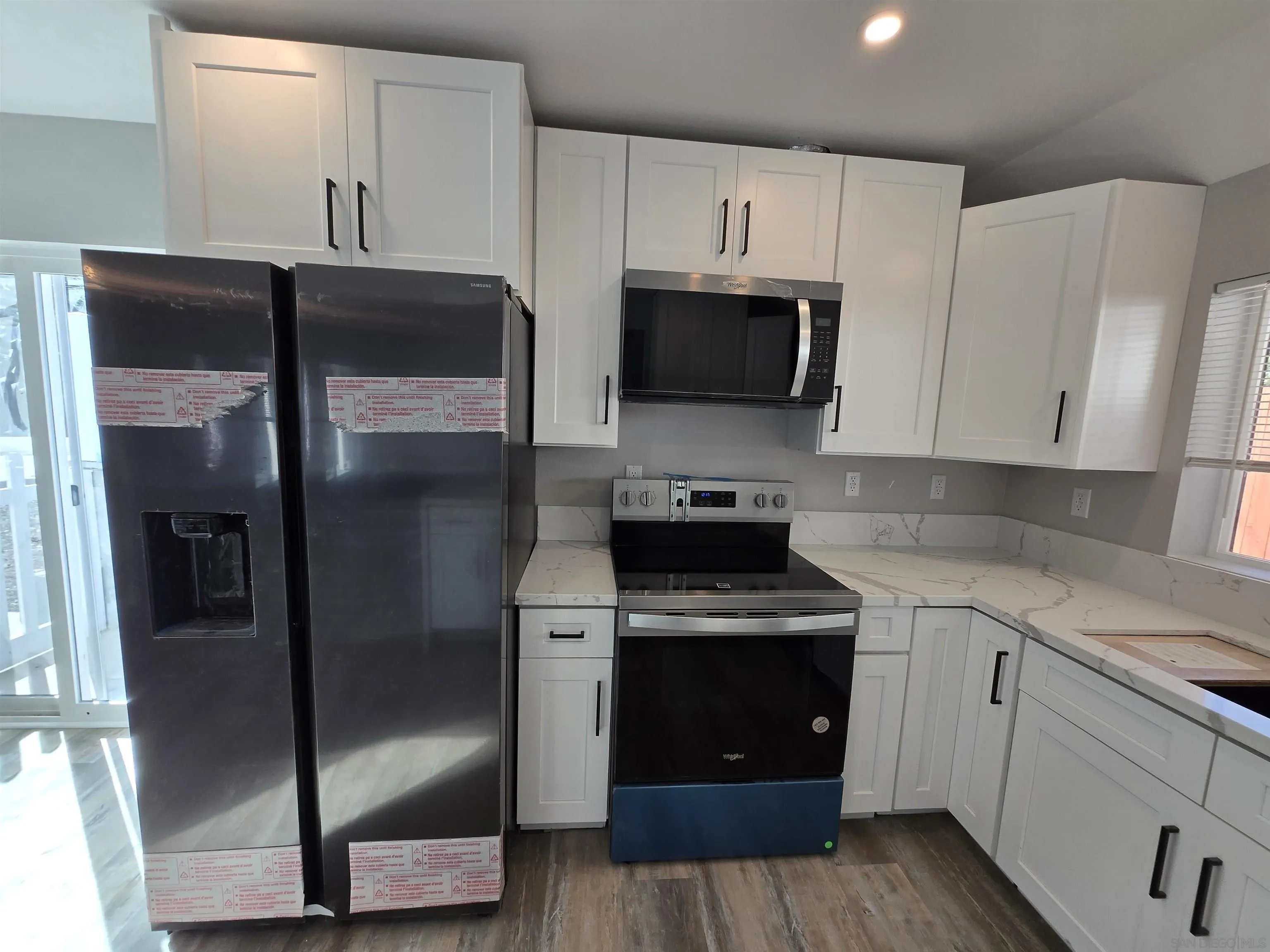 940 South Upas Street Escondido, CA 92025 - Photo 6 of 55 a kitchen with cabinets stainless steel appliances and wooden floor
