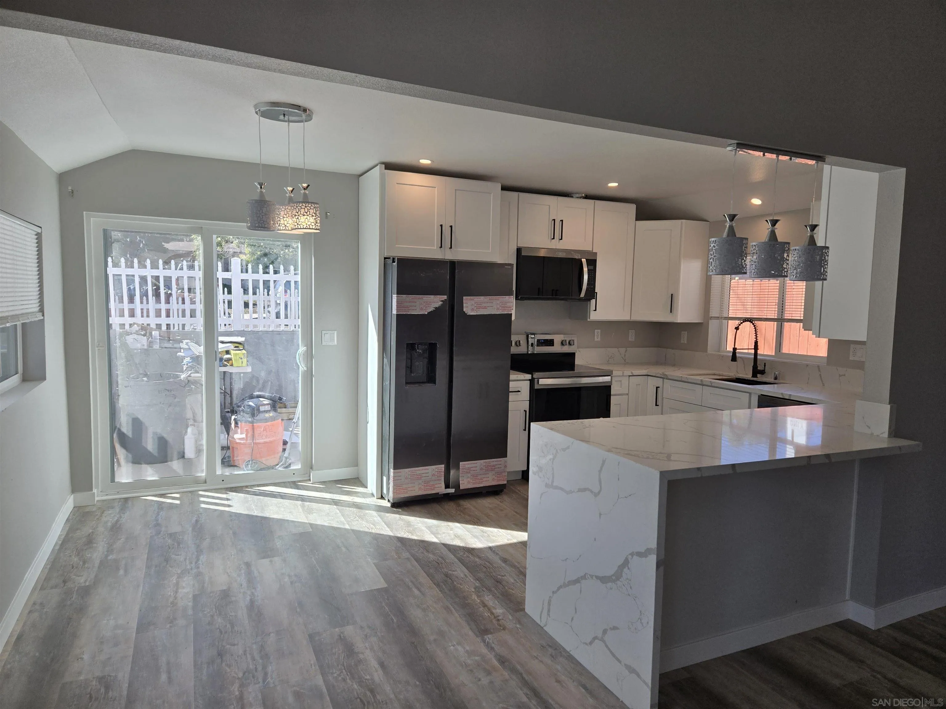 940 South Upas Street Escondido, CA 92025 - Photo 7 of 55 a kitchen with stainless steel appliances a refrigerator and a stove top oven