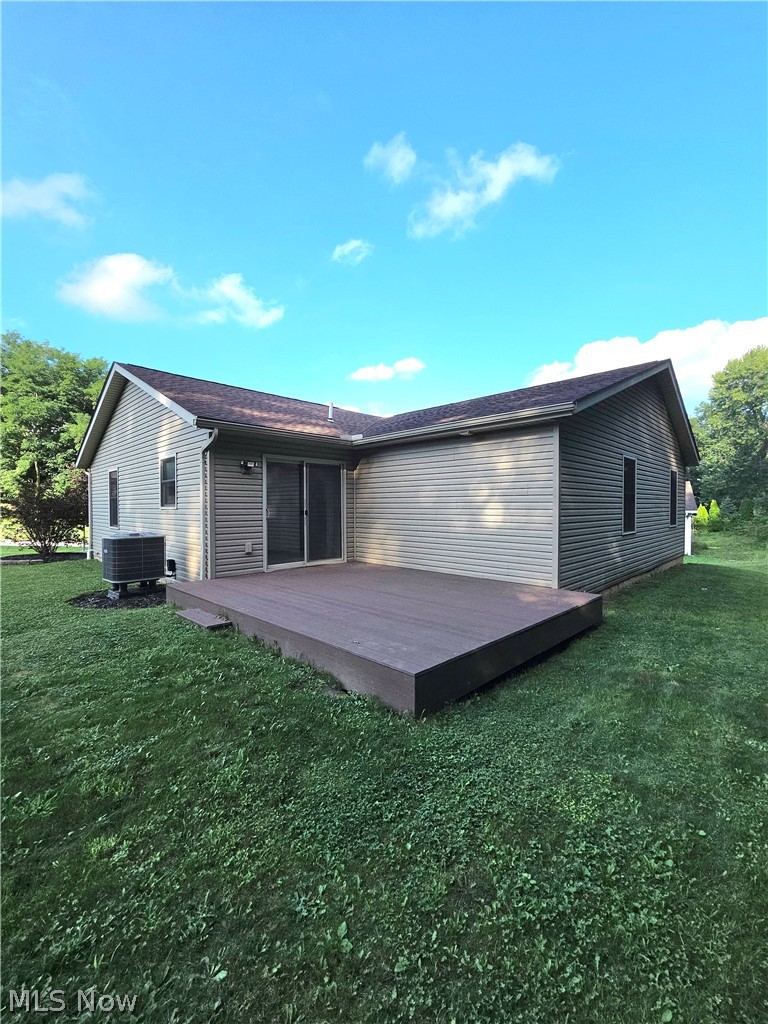 202 Home Street Rittman, OH 44270 - Photo 3 of 23 Spacious backyard featuring a large low-profile deck, siding exterior, and sliding glass doors