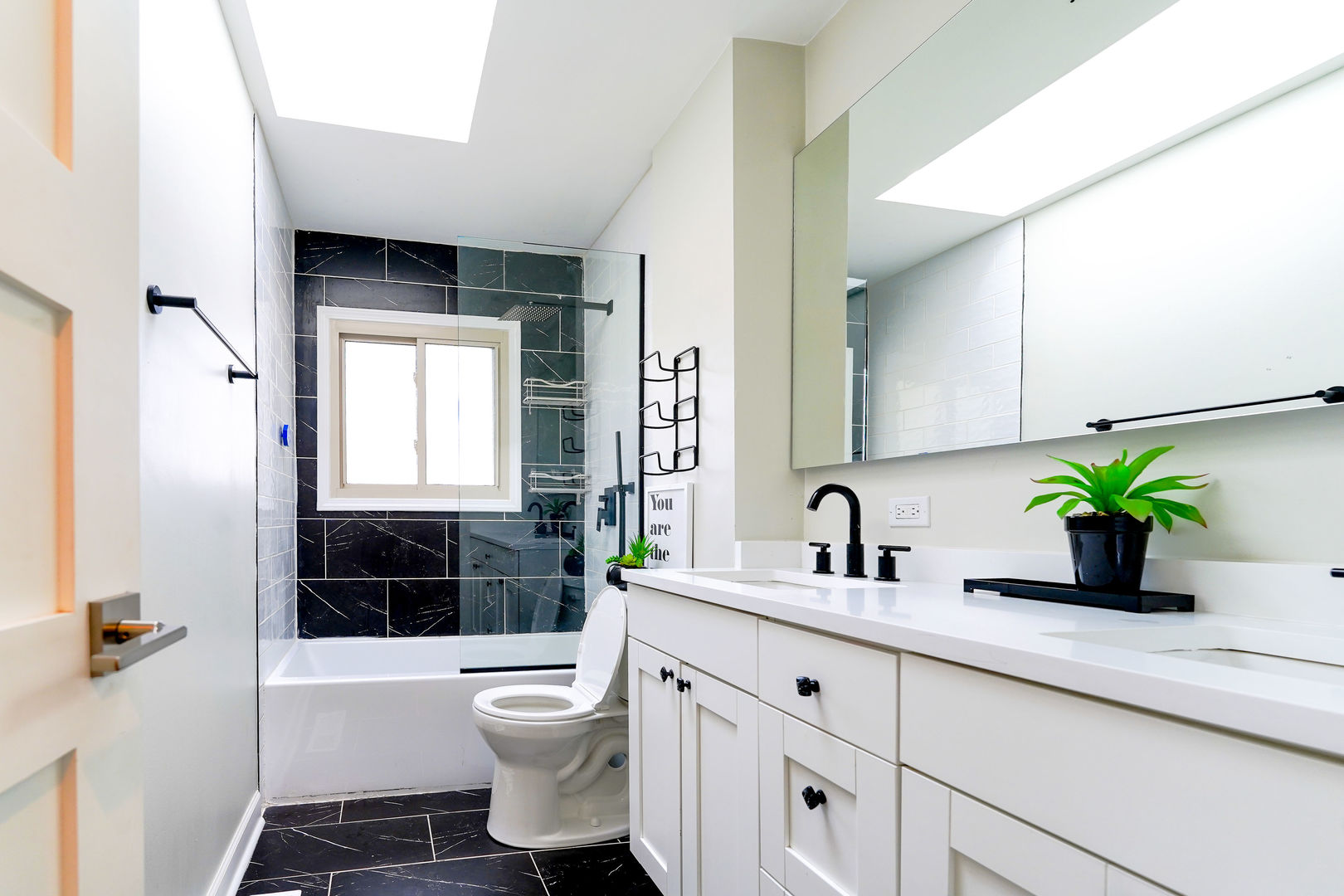 21W272 Coronet Road Lombard, IL 60148 - Photo 15 of 31 a bathroom with a granite countertop sink a toilet a window and shower