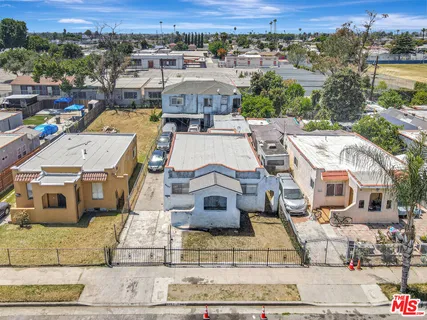 an aerial view of a house with a yard
