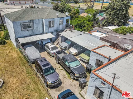 an aerial view of a house with swimming pool and outdoor seating
