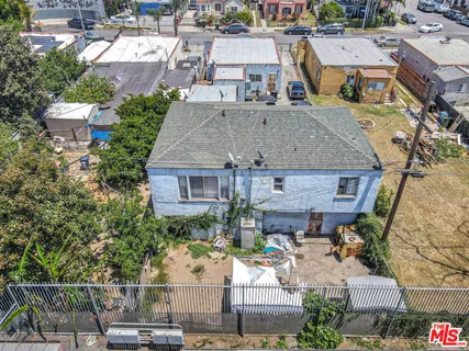 an aerial view of multiple houses with a yard