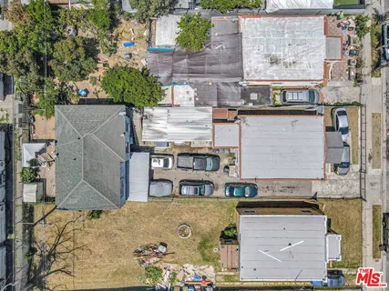an aerial view of a house with a yard