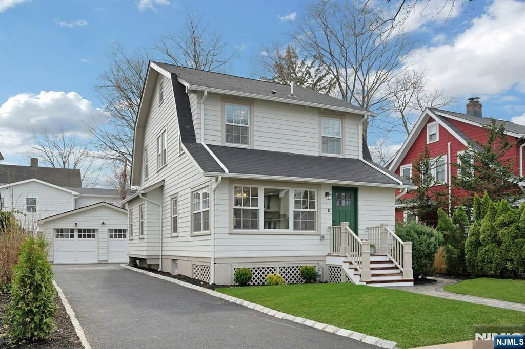 a front view of a house with a yard and outdoor seating
