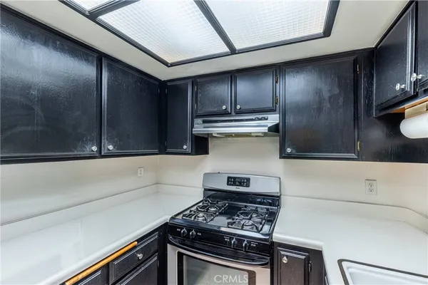 a kitchen with a stove and a refrigerator