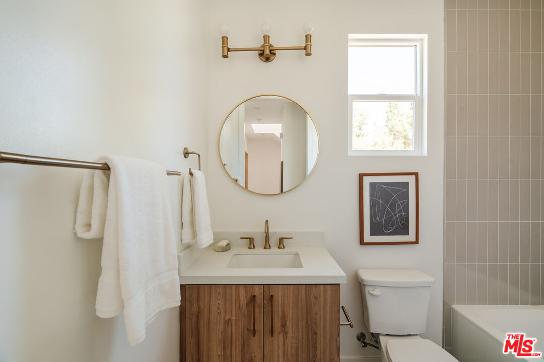 3872 North Riley Lane Los Angeles, CA 90065 - Photo 14 of 30 a bathroom with a granite countertop sink mirror vanity and a toilet