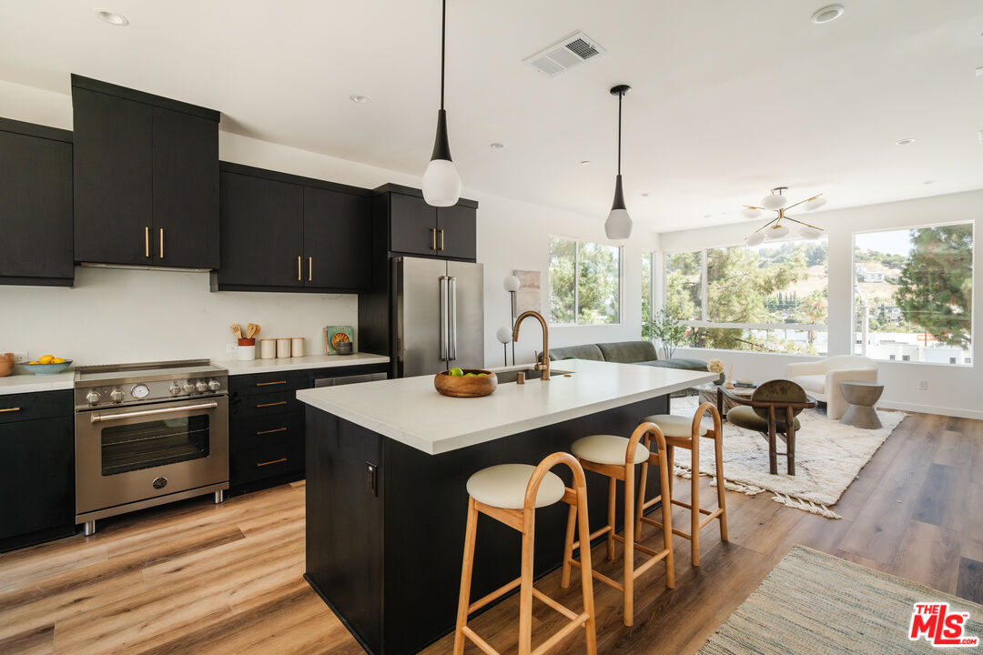 3872 North Riley Lane Los Angeles, CA 90065 - Photo 4 of 30 a kitchen with stainless steel appliances granite countertop a sink a stove and a refrigerator