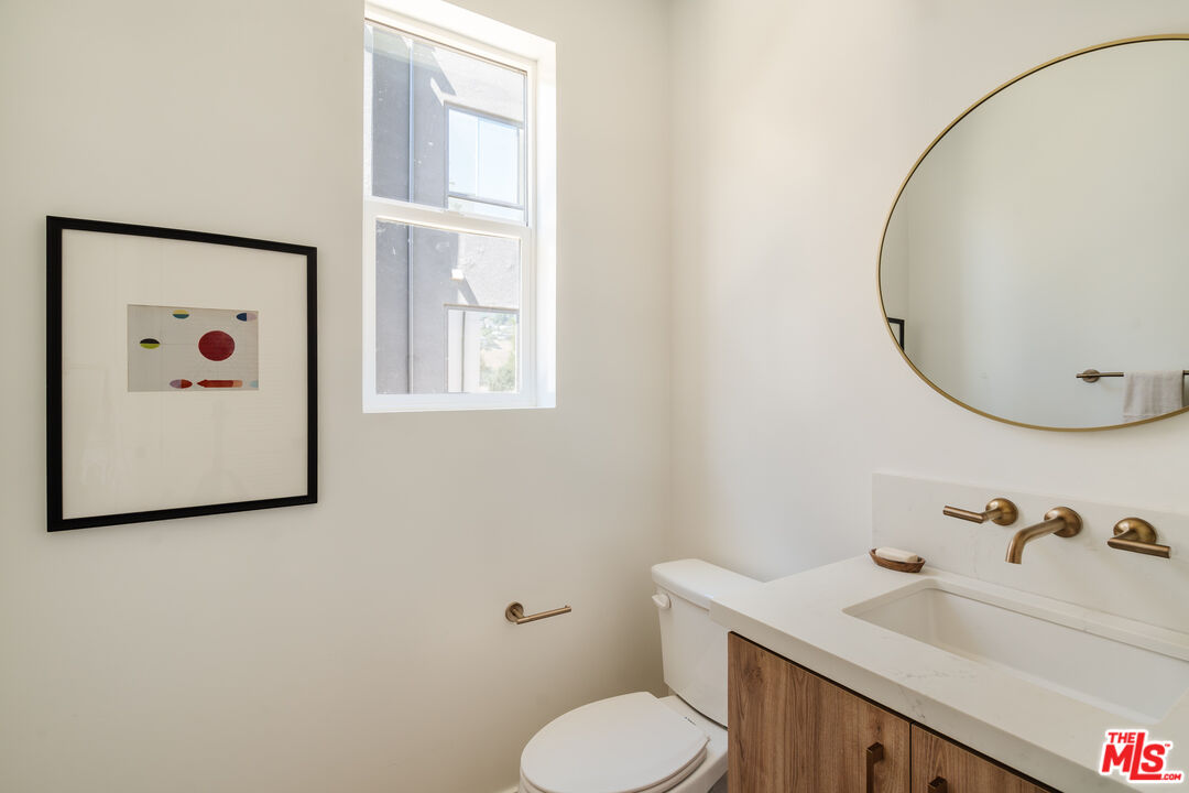 3872 North Riley Lane Los Angeles, CA 90065 - Photo 6 of 30 a bathroom with a toilet sink and mirror