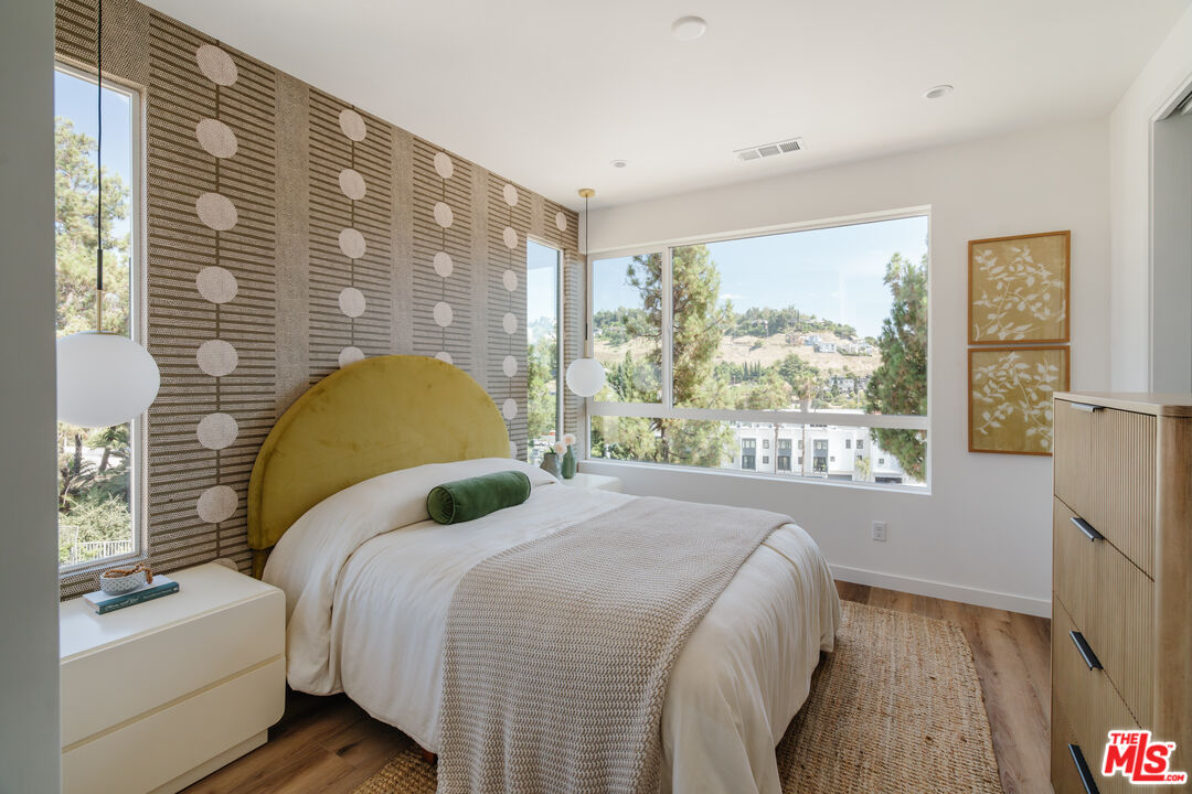 3872 North Riley Lane Los Angeles, CA 90065 - Photo 9 of 30 a bedroom with a bed and a large window