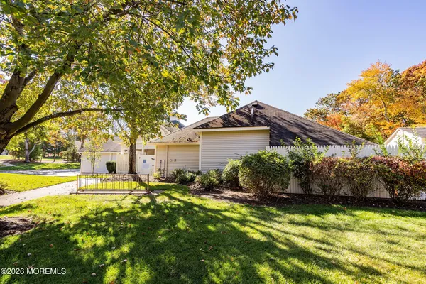 a front view of house with yard and trees around