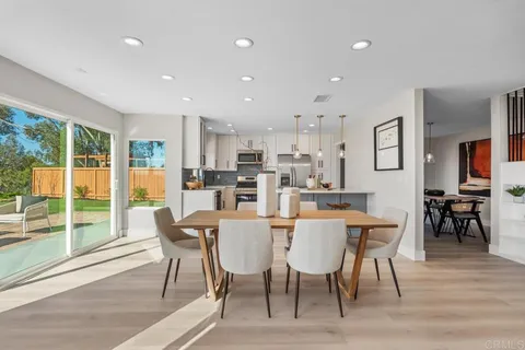 a kitchen with kitchen island a refrigerator a stove a sink and a center island